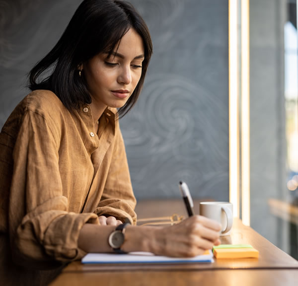 women writing on a pad