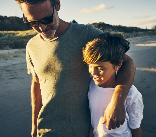 Father and son walking on beach